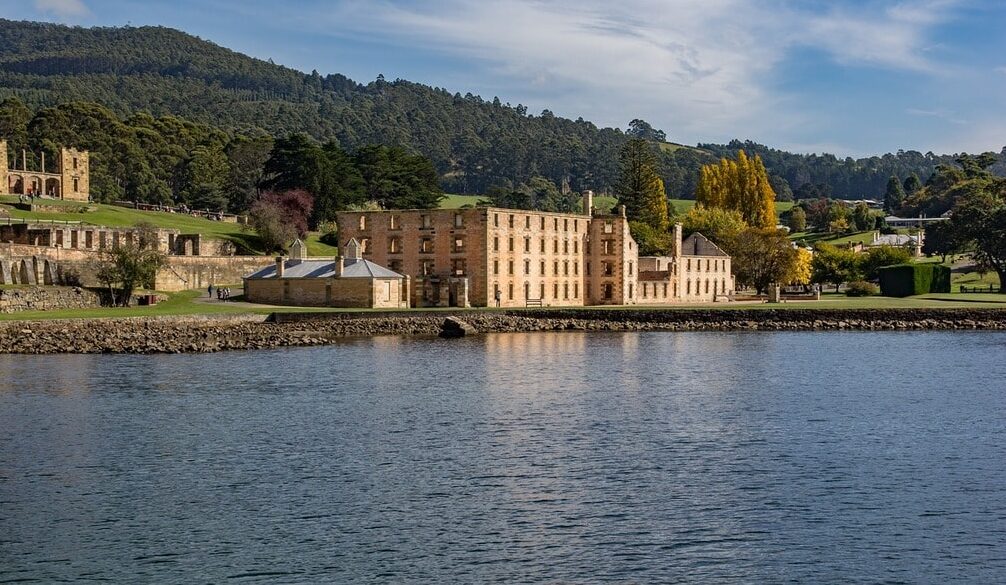  "Aerial view of Port Arthur, Tasmania, surrounded by lush greenery."