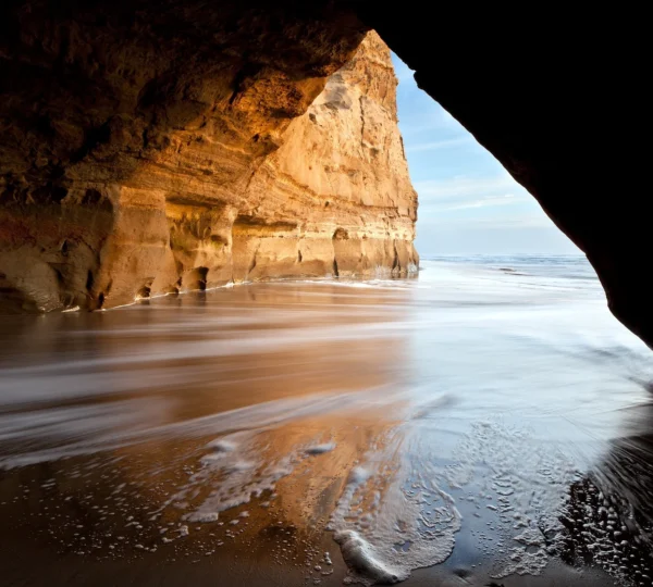 Sea cave entrance with waves crashing, Ballybunion Beach