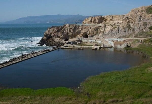 "Ruins of Sutro Baths on rocky shore in San Francisco, California.